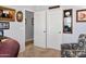 Bright room featuring double doors, neutral paint, and plush chair; offering a flexible space to meet your needs at 907 E Kelsi Ave, San Tan Valley, AZ 85140