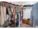 Organized walk-in closet with hanging clothes and shelving at 907 E Kelsi Ave, San Tan Valley, AZ 85140