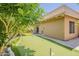 The backyard features a putting green with mature trees, a tan stucco wall, and a stone tile at 9196 E Evans Dr, Scottsdale, AZ 85260