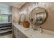 Bathroom with double sinks, wood cabinets, framed mirrors, and a view of the bedroom at 9196 E Evans Dr, Scottsdale, AZ 85260