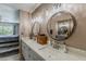 Bright bathroom featuring dual sinks, contemporary lighting, and a view of the bedroom and vanity area at 9196 E Evans Dr, Scottsdale, AZ 85260