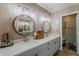 Elegant bathroom with dual sinks, round mirrors, and modern lighting fixtures, providing a spa-like atmosphere at 9196 E Evans Dr, Scottsdale, AZ 85260
