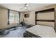 Multi-purpose bedroom featuring modern excercise equipment, a ceiling fan, and a murphy bed at 9196 E Evans Dr, Scottsdale, AZ 85260