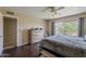 Bright bedroom with wood floors, a dresser, and a window overlooking the private backyard at 9196 E Evans Dr, Scottsdale, AZ 85260