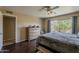 Bedroom featuring a queen-sized bed, wood floors, and a cozy atmosphere with natural light at 9196 E Evans Dr, Scottsdale, AZ 85260