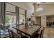 Dining room with backyard view, featuring a rustic wood table and a patio with outdoor seating at 9196 E Evans Dr, Scottsdale, AZ 85260
