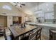 Open-concept kitchen and dining area with vaulted ceilings, stainless steel appliances, and a rustic dining table at 9196 E Evans Dr, Scottsdale, AZ 85260