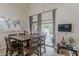 Cozy dining area with rustic wood table and chairs, flowing seamlessly to the outdoor patio through sliding glass doors at 9196 E Evans Dr, Scottsdale, AZ 85260