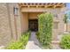 Inviting home entryway featuring stone columns and lush greenery at 9196 E Evans Dr, Scottsdale, AZ 85260