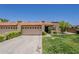 A single story home with 3 garage doors, a tile roof and well maintained landscaping at 9196 E Evans Dr, Scottsdale, AZ 85260
