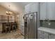 Kitchen with stainless steel appliances, custom cabinets, breakfast bar, and decorative tile backsplash at 9196 E Evans Dr, Scottsdale, AZ 85260