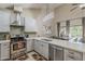 Eat-in kitchen featuring stainless appliances, neutral countertops and a large dining table at 9196 E Evans Dr, Scottsdale, AZ 85260