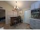 Kitchen area features a cozy bar with seating and modern cabinets with stainless steel microwave at 9196 E Evans Dr, Scottsdale, AZ 85260