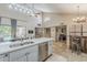 Spacious kitchen featuring stainless steel appliances and views of the living room at 9196 E Evans Dr, Scottsdale, AZ 85260