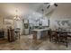Open-concept kitchen and dining area with stainless appliances, tile backsplash, and modern lighting fixtures at 9196 E Evans Dr, Scottsdale, AZ 85260