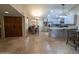 Open concept layout showing the kitchen and living spaces with travertine floors and modern finishes at 9196 E Evans Dr, Scottsdale, AZ 85260
