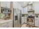 Bright kitchen showcasing stainless steel refrigerator and ample cabinet space at 9196 E Evans Dr, Scottsdale, AZ 85260