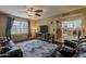 Cozy living room with wood flooring, neutral walls, a ceiling fan, and a large window offering natural light at 9196 E Evans Dr, Scottsdale, AZ 85260