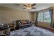 Comfortable living room with hardwood floors, neutral paint, a ceiling fan, and plenty of natural light at 9196 E Evans Dr, Scottsdale, AZ 85260