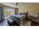 Bedroom featuring a king-size bed, an outdoor patio view, and a wooden frame at 9196 E Evans Dr, Scottsdale, AZ 85260