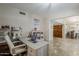 Bright office features a stylish desk, chair, arched doorway and wood door to outside at 9196 E Evans Dr, Scottsdale, AZ 85260