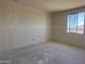 A bright bedroom under construction featuring a new window and walls prepped for paint at 9531 W Parkway Dr, Tolleson, AZ 85353