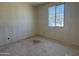 A bright bedroom under construction featuring a new window and walls prepped for paint at 9531 W Parkway Dr, Tolleson, AZ 85353