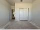 Neutral bedroom with sliding closet doors, offering practical storage solutions and clean design at 9531 W Parkway Dr, Tolleson, AZ 85353