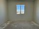 Bright bedroom with a large window offering ample natural light and serene neighborhood views at 9531 W Parkway Dr, Tolleson, AZ 85353