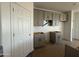 Unfinished kitchen features stylish gray cabinetry and hardware at 9531 W Parkway Dr, Tolleson, AZ 85353