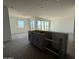 View of large kitchen island with sink looking out to living area at 9531 W Parkway Dr, Tolleson, AZ 85353