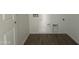 Functional laundry room with tile flooring, designed for efficiency and convenience at 9531 W Parkway Dr, Tolleson, AZ 85353