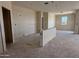 Open-concept living room featuring prepped walls, recessed lighting fixtures, and a view of the backyard at 9531 W Parkway Dr, Tolleson, AZ 85353