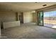 A modern living room under construction with large sliding doors, awaiting its final touches and design at 9531 W Parkway Dr, Tolleson, AZ 85353