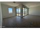 Spacious living area with large windows and sliding glass doors to backyard at 9531 W Parkway Dr, Tolleson, AZ 85353