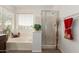 Bathroom showcasing a tub, separate shower, and towel rack with decor adding a touch of elegance at 9649 S 51 St St, Phoenix, AZ 85044
