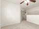 Spacious bedroom features plush carpeting, a ceiling fan, and a white closet at 9649 S 51 St St, Phoenix, AZ 85044