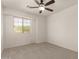 A bright and airy carpeted bedroom with ceiling fan and a window offering natural light at 9649 S 51 St St, Phoenix, AZ 85044