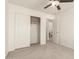 Carpeted bedroom with closet doors and doorway view into the bathroom at 9649 S 51 St St, Phoenix, AZ 85044