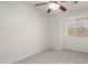 Neutral bedroom featuring soft carpeting, a ceiling fan, and a window at 9649 S 51 St St, Phoenix, AZ 85044
