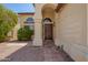 A close up of the front door and arched entryway with stone walkway at 9649 S 51 St St, Phoenix, AZ 85044