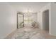 Bright, neutral room with tile floors, large mirror, and natural light at 9649 S 51 St St, Phoenix, AZ 85044