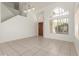 Bright, open living room with tile floors, neutral walls and front door view at 9649 S 51 St St, Phoenix, AZ 85044