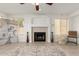 Bright living room featuring a fireplace, tile flooring, and large windows at 9649 S 51 St St, Phoenix, AZ 85044