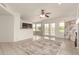 Spacious living room with tile floors, a ceiling fan, and natural light at 9649 S 51 St St, Phoenix, AZ 85044