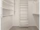 Bright walk-in closet boasts shelving and plenty of space to hang clothes at 9649 S 51 St St, Phoenix, AZ 85044