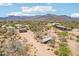 A sprawling desert lot with a home and stable offers plenty of space for animals at 10600 E Cordova St, Gold Canyon, AZ 85118