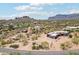 Wide aerial shot displaying desert community living with distant mountain views and native trees at 10600 E Cordova St, Gold Canyon, AZ 85118