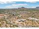 Aerial view showing the home and community surrounded by arid desert and mountains at 10600 E Cordova St, Gold Canyon, AZ 85118