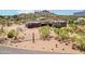Aerial view of home displaying beautiful desert landscaping, mountain views, and its serene setting at 10600 E Cordova St, Gold Canyon, AZ 85118
